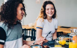 Teenagers eating bacon and eggs