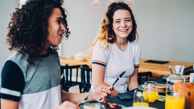 Teenagers eating bacon and eggs