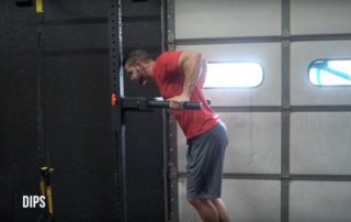 man performing a dip exercise at the gym