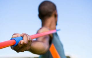 Close-up of athlete about to throw a javelin in the stadium