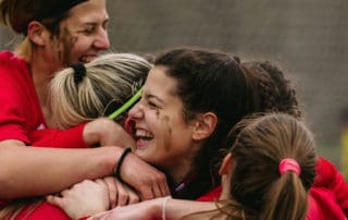 Happy female soccer players celebrating goal.