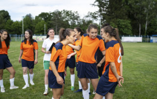 Young soccer players having argument on the field