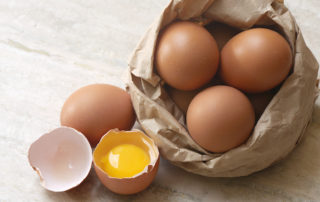 Bag of eggs with one cracked open