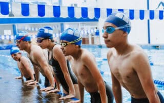 image of youth swimmers practicing together in pool