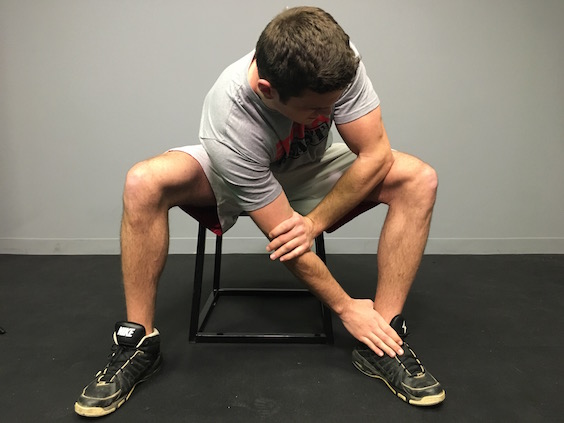 personal trainer performing stretch