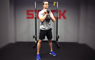 man performing a goblet squat exercise